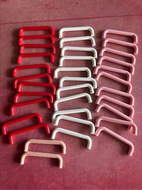 35 pc collection of plastic drawer pulls (reds, whites, and pinks)